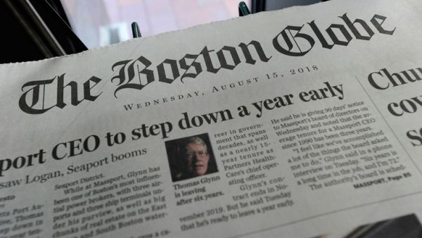 Copies of the Boston Globe are seen at a newspaper stand. (AFP/ File)