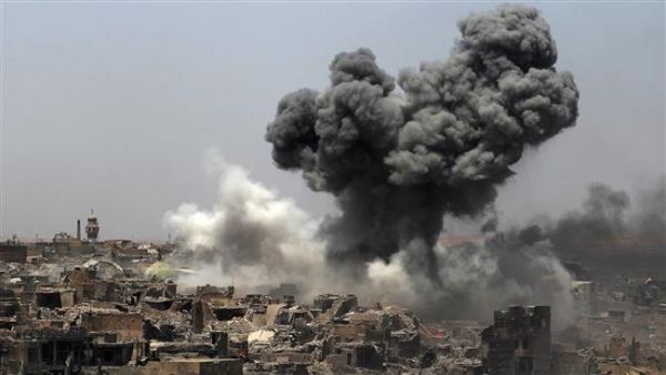 A picture taken on July 9, 2017, shows smoke billowing following an airstrike by US-led international coalition forces in Mosul, Iraq. (AFP)