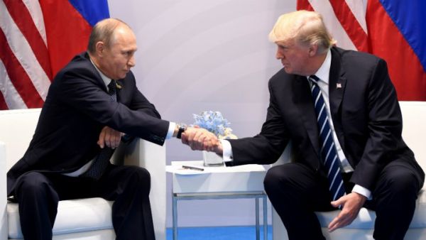 US President Donald Trump and Russia's President Vladimir Putin shake hands during a meeting on the sidelines of the G20 Summit in Hamburg, Germany, on July 7, 2017. (AFP/ Saul Loeb)
