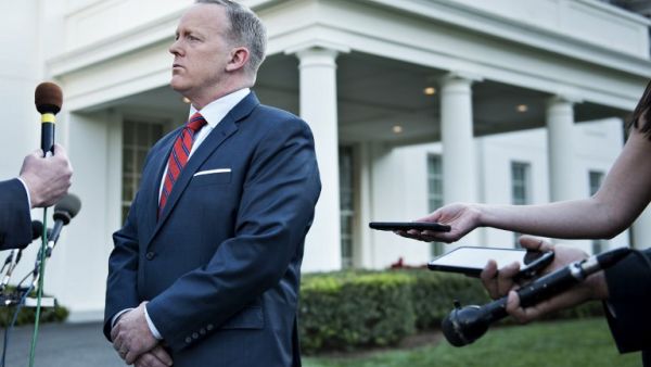 White House Press Secretary Sean Spicer speaks to a reporter about a comparison he made between Syria's President Bashar al-Assad and Hitler during an earlier press briefing at the White House April 11, 2017 in Washington, DC. (AFP/Brendan Smialowski)