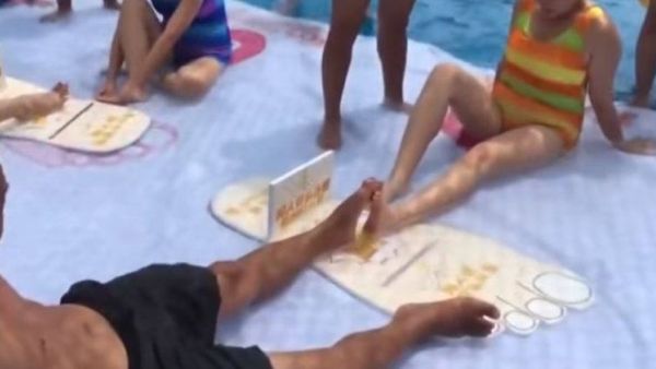 The bizarre match involves two opponents locking their feet and attempting to ping each other's foot down (Screenshot)