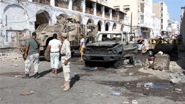 People gather at the site of a car bomb explosion next to the central bank in Yemen's second city of Aden. (AFP/ File)