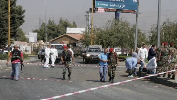 Lebanese security forces and forensics check the site of a bomb blast in Zahle, near the border with Syria. (AFP/Hassan Jarrah)