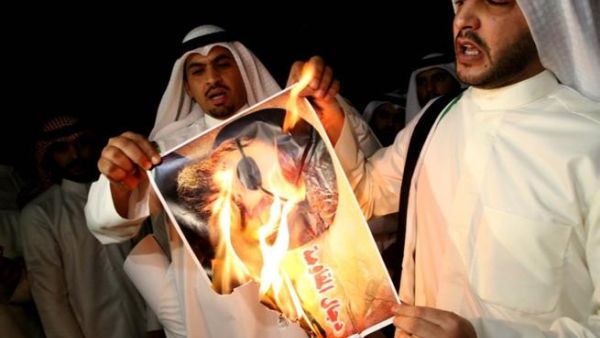Kuwaiti protesters set ablaze a picture of Lebanese Shiite movement Hezbollah's chief Hassan Nasrallah during a protest in front the Lebanese embassy against Hezbollah's and Iran's involvement in Syria, in Kuwait city on June 11 (Yasser al-Zayyat / AFP)