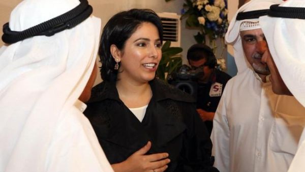 Kuwaiti Reham al-Jlewe (C), a candidate in Kuwait's upcoming parliamentary elections, welcomes her guests at her election campaign tent in Kuwait City (Yasser al-Zayyat / AFP)