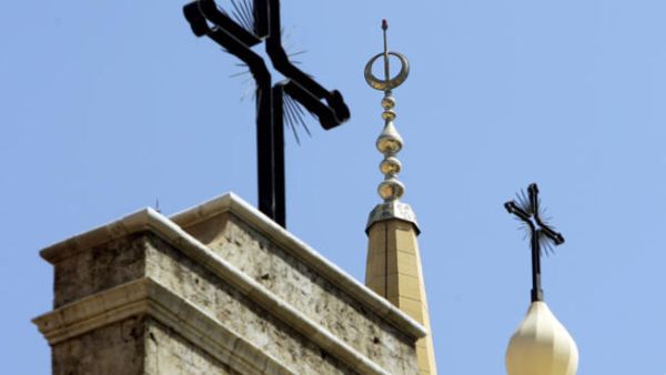 Church steeples stand amongst mosque minarets in religiously diverse Beirut, Lebanon.  (AFP/Joseph Eid)