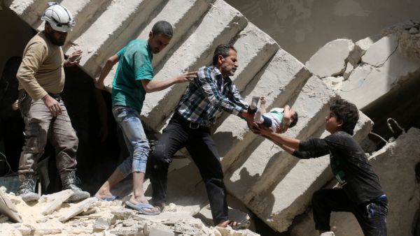 Residents of Aleppo's al-Kalasa district rescue a toddler after an air raid destroyed his home on April 28, 2016. (AFP/Ameer Alhalbi)   