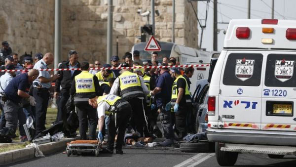 Israeli emergency personnel and security forces gather at the scene of an attack outside Jerusalem's Old City's New Gate on March 9, 2016. (AFP/Ahmad Gharabli)