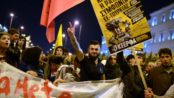 A Syrian man flashes a victory sign during a demonstration by in Greece stranded refugees and supporting groups in Athens on March 30, 2016. (AFP/Louisa Gouliamaki) A Syrian man flashes a victory sign during a demonstration by in Greece stranded refugees and supporting groups in Athens on March 30, 2016. (AFP/Louisa Gouliamaki)