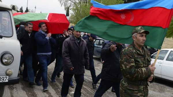 Men carry the coffin of an Azerbaijan's serviceman, who was killed on April 2 during clashes between Armenian and Azeri forces in Armenian-seized Azerbaijani region of Nagorny Karabakh, during his funeral in Terter on April 3, 2016. (AFP/Tofik Babayev)