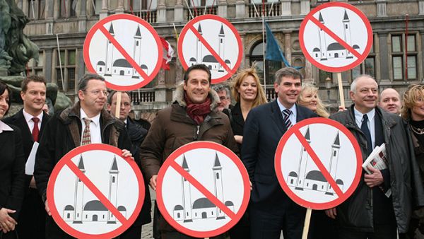 Members of several European right-wing parties pose with signs, after the presentation of their organization of "Cities against Islamization" in Antwerp. (AFP/Jorge Dirkx)