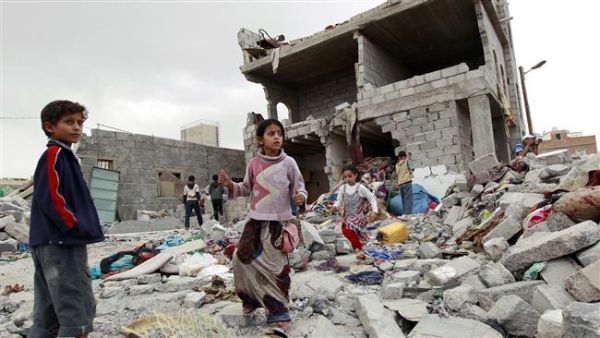 Children walk through the rubble after an airstrike in Sana'a, north of Taiz. (AFP/File)