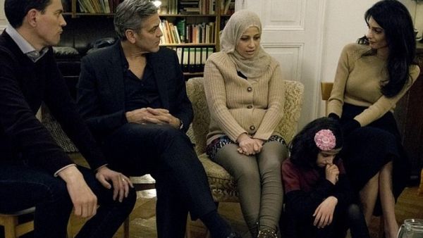 The Clooneys in conversation with a Syrian refugee in Berlin. (Munsif.tv)