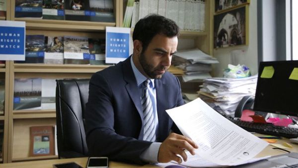 Human Rights Watch's Israel and Palestine director Omar Shakir, a US citizen, sits at his office in the West Bank city of Ramallah on May 9, 2018. (AFP / ABBAS MOMANI)