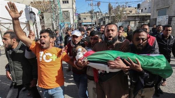 Mourners carry the body of a four-year-old Palestinian boy, who died of Israeli-inflicted wounds, during his funeral in Khan Yunis, Gaza Strip. (AFP)
