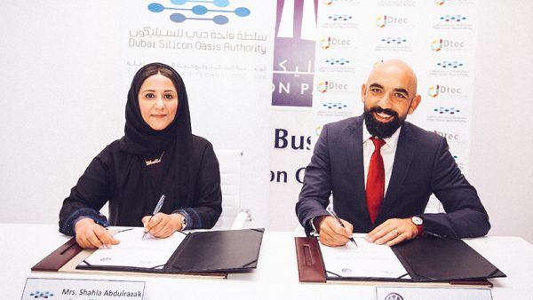 Shahla Ahmed Abdul Razak, deputy chief executive of DSOA, and Andrew Savvas, brand director of Volkswagen Middle East, during the signing ceremony. 
