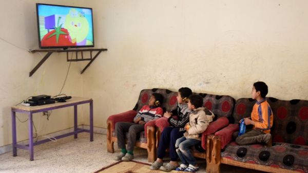 The mother stood with a poster advertising her three children for sale (AFP/File)