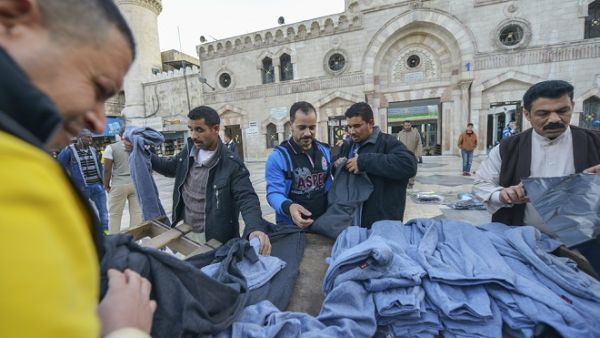People buying clothes in front of Al-Husseini Mosque on December 9, 2016, in downtown Amman. (Shutterstock)