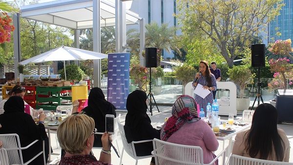 Female employee talking about her career journey during the event.