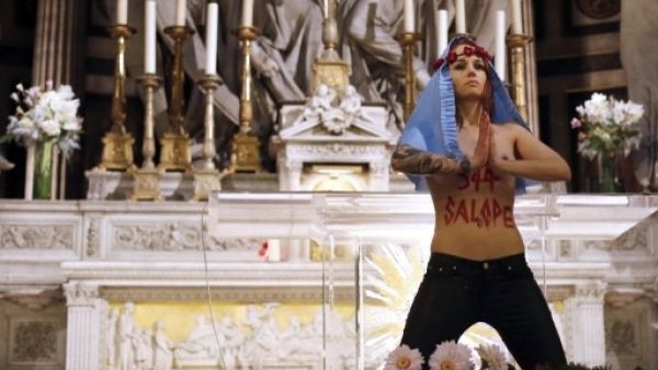 A Femen activist makes a protest at a French church in 2013 (AFP / File)