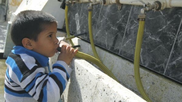 A Palestinian boy drinking water from a clean source in the Gaza Strip. (AFP/File)