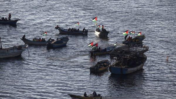 Palestinians sail boats bearing their national flag in the port of Gaza City in support of the Gaza-bound flotilla of international female activists attempting to break the Israeli blockade on the Hamas-run Gaza Strip on October 5, 2016. (AFP/Mahmud Hams)
