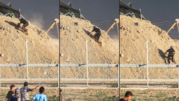 فلسطيني يجتاز السياج الفاصل ويصعد إلى تلة يتمركز بها قناصة الاحتلال شرق مدينة غزة ليصبح أمامهم وجها لوجه.
