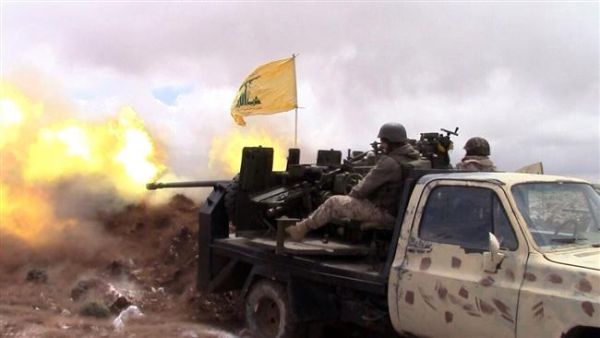 A handout picture released by the Hezbollah press office on May 16, 2015, shows a Hezbollah fighter firing toward areas controlled by militants on the Syrian side of the Qalamoun hills close to the Lebanese border. (AFP/File)