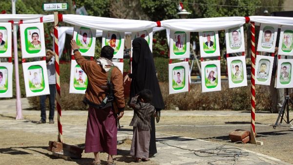 Yemenis look at portraits of Shiite Huthi rebels, reportedly killed in fighting against Saudi-backed Yemeni forces, displayed during an exhibition marking their "Martyrs' Day" on February 27, 2016 in the capital Sanaa. (AFP/Mohammed Huwais)