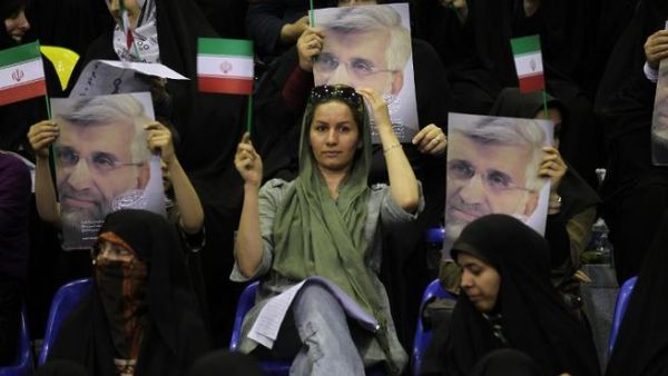 Supporters hold portraits of Iranian presidential candidate and lead nuclear negotiator Saeed Jalili during a campaign rally in Tehran on May 24 (Atta Kenare / AFP)