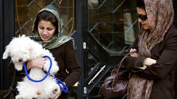 A woman enjoying her dog outdoors. [content.time]
