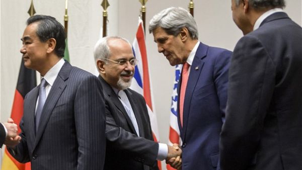 Iranian Foreign Minister Mohammad Javad Zarif shakes hands with US Secretary of State John Kerry after a statement to announce a landmark deal with Iran halting parts of its nuclear program. (AFP/File)