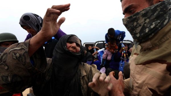 An Iraqi family fleeing the violence in the northern city of Mosul arrive at a Kurdish checkpoint in Makhmur, about 175 miles north of the capital Baghdad, on March 26, 2016. (AFP/Safin Hamed)