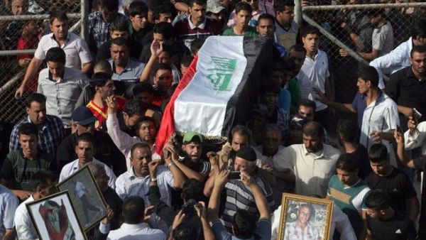 Family and friends carry the coffin of Iraqi Karbala Club football coach Mohammad Abbas, during his funeral in the central Iraqi city of Karbala. Abbas and some team members were allegedly beaten by security forces (AFP)