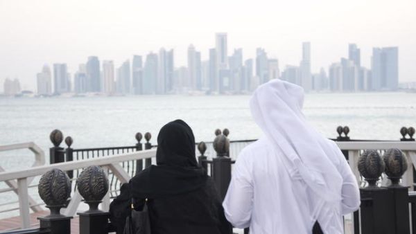 A Qatari man and woman look out at the Doha skyline. (Albawaba/ J. Zach Hollo)