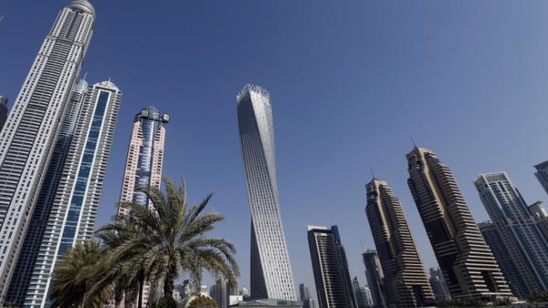 The Cayan tower (C), the world's tallest twisted tower stands at Dubai's Marina on June 11, 2013 in the United Arab Emirates, UAE. (AFP/KARIM SAHIBSAHIB)