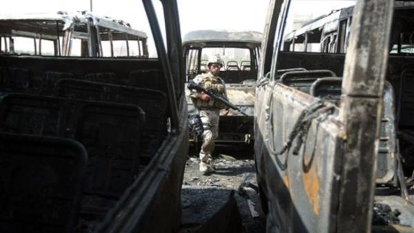 جندي عراقي بين حافلات محترقة في بغداد اثر تفجير/أ.ف.ب