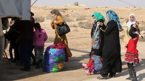 Iraqi women and children who have fled Fallujah wait at an army checkpoint. (AFP/Ahmad al-Rubaye)