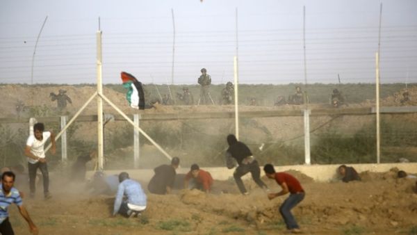 Israeli forces fire at Palestinians trying to cut border fence between Israel and Gaza Strip on Friday (AFP)