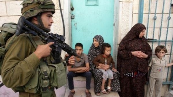 An Israeli soldier patrols a Palestinian town in the West Bank (AFP/File Photo)

