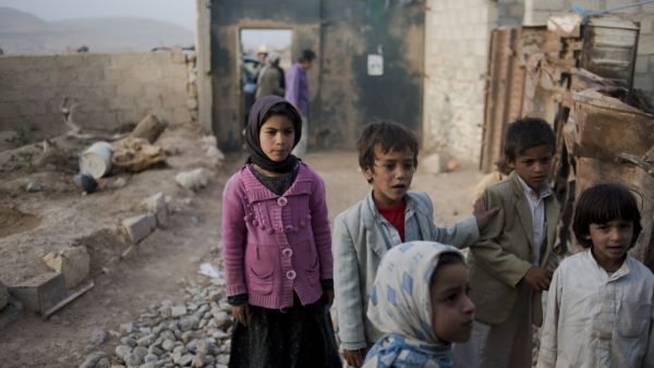 Yemeni children stand outside the Huwaiti home, as the mother of Mohammad and Ahmad mourns. She lost both of her sons, ages 17 and 14, who were selling produce on the side of the road, to a Saudi-led coalition airstrike in Al Joob village. (Alex Potter)