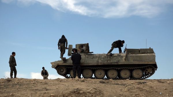 Fighters from the Syrian Democratic Forces (SDF) sit atop an armored personnel carrier in the northeastern Syrian province of Hasakeh, on February 19, 2016. (AFP/Delil Souleiman)