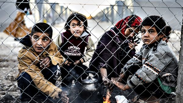 A Syrian Kurdish woman and her children wait in a refugee camp in Turkey. (AFP/Bulent Kilic)