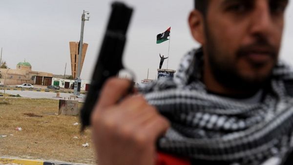 A rebel fighter stands at a roundabout in the center of town in Ajdabiya, Libya on March 15, 2011. (Roberto Schmidt/ AFP)