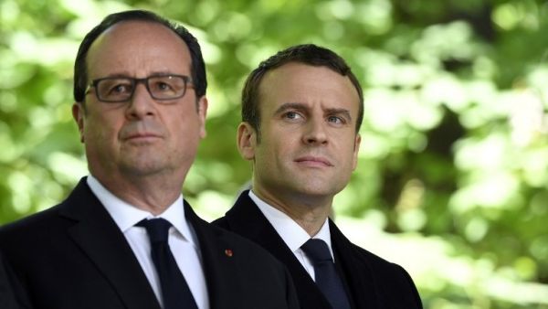 Then French President Francois Hollande (L) and French President-elect Emmanuel Macron at a special ceremony at the Jardin du Luxembourg, on May 10, 2017. (AFP/ Eric Feferberg)