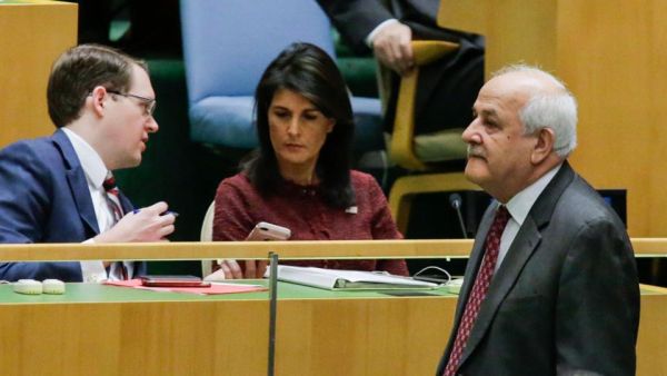 Riyad H. Mansour, (R) Palestine's Ambassador to the United Nations walks pass by US Ambassador to the UN Nikki Haley as he attends the General Assembly for the vote on Jerusalem, on December 15, 2017, at UN Headquarters in New York. (AFP)
