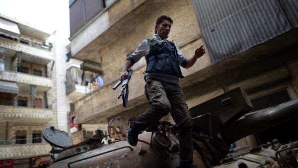 A Syrian rebel patrols an area in the Sheikh Maqsud district of the northern Syrian city of Aleppo, on Thursday. (AFP PHOTO / DIMITAR DILKOFF)
