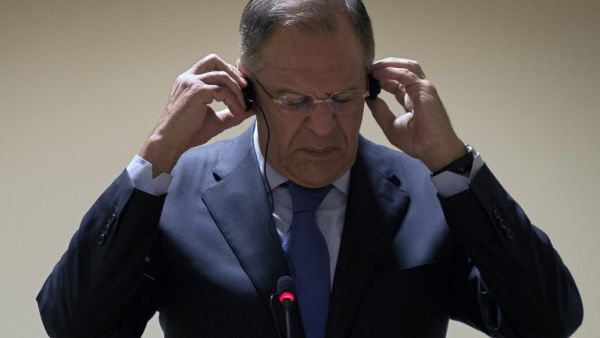 Russian Foreign Minister Sergei Lavrov straightens the headphones during a press conference in Rio de Janeiro, Brazil on June 11 (Vanderlei Almeida / AFP)