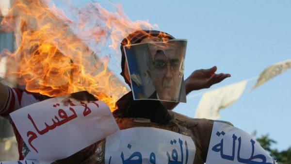 Protestors burned effigies of Prime Minister Salam Fayyad