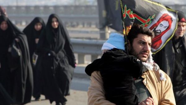 Clutching at straws: an Iraqi man holds on to his child on the main highway into the capital (used for illustrative purposes only)
